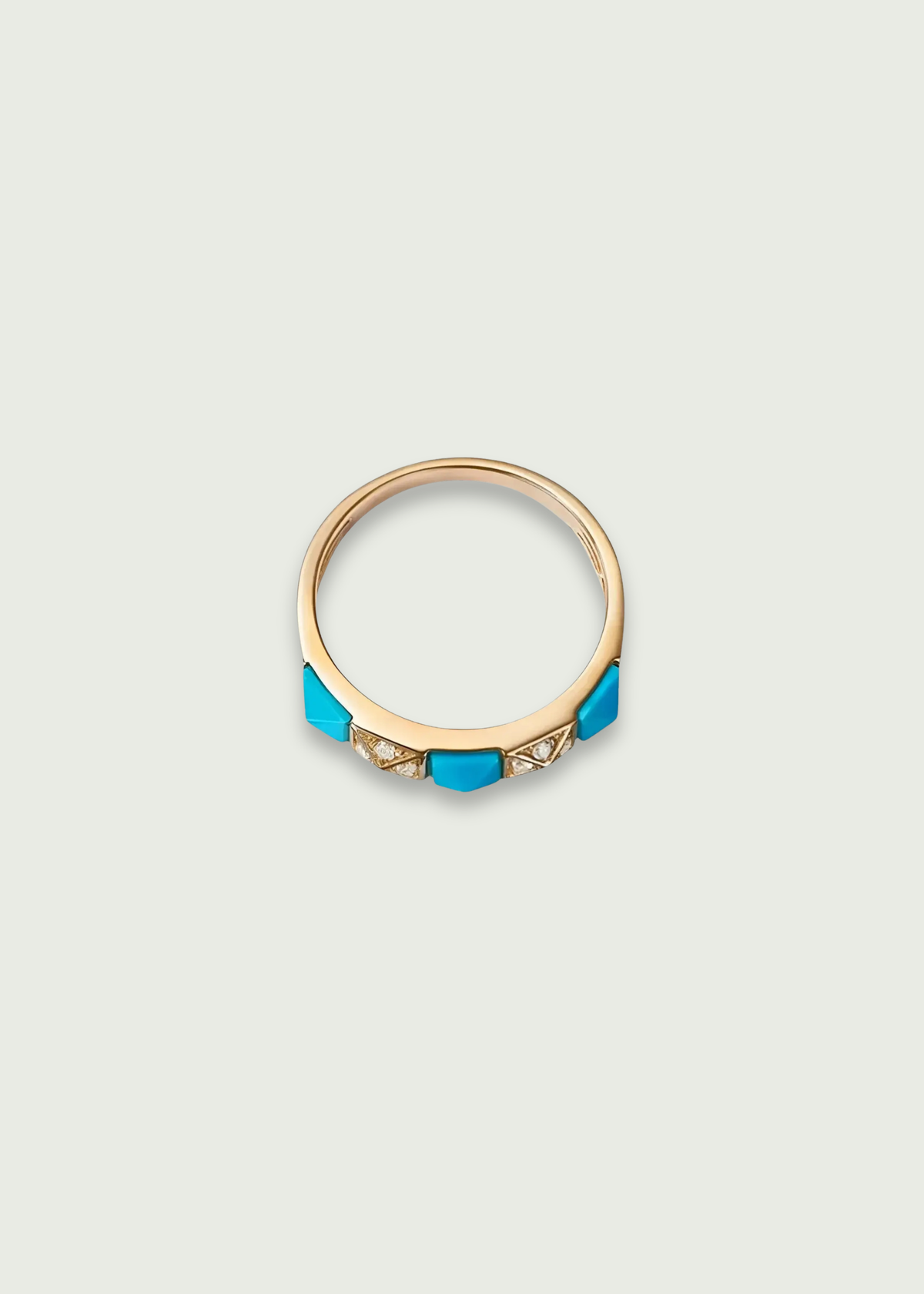 Turquoise and diamond wedding band featuring a sleek yellow gold band with turquoise and diamond accents.