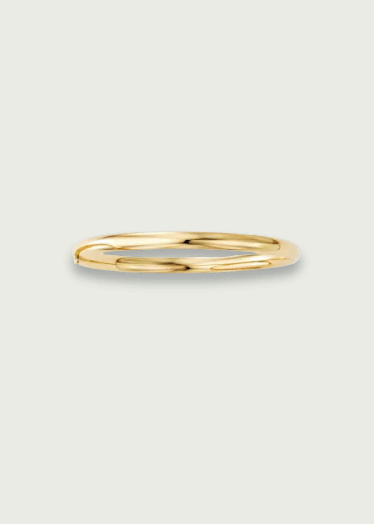 10K gold bangle bracelet showcasing a sleek design, perfect for stacking or wearing alone.